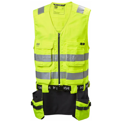 Helly Hansen Alna 2.0 Construction Vest - funksjonell håndverkervest med 2-veis stretchmateriale, forbedret passform, forlengbar front, sømløse refleksbånd for økt sikkerhet, designet for komfort og stil for profesjonelle håndverkere.